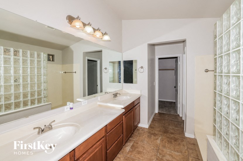 a bathroom with two sinks and a large mirror