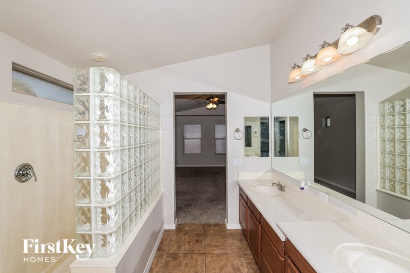a large bathroom with two sinks and a large mirror
