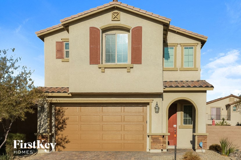 a house with a garage door in front of it