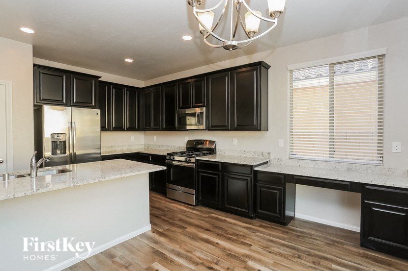 a kitchen with black cabinets and white counter tops