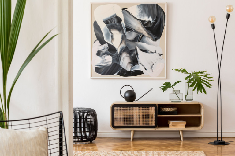 a living room with a couch and a painting on the wall
