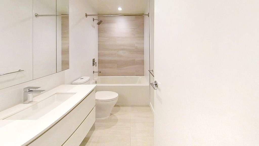 a bathroom with a sink and a toilet and a shower