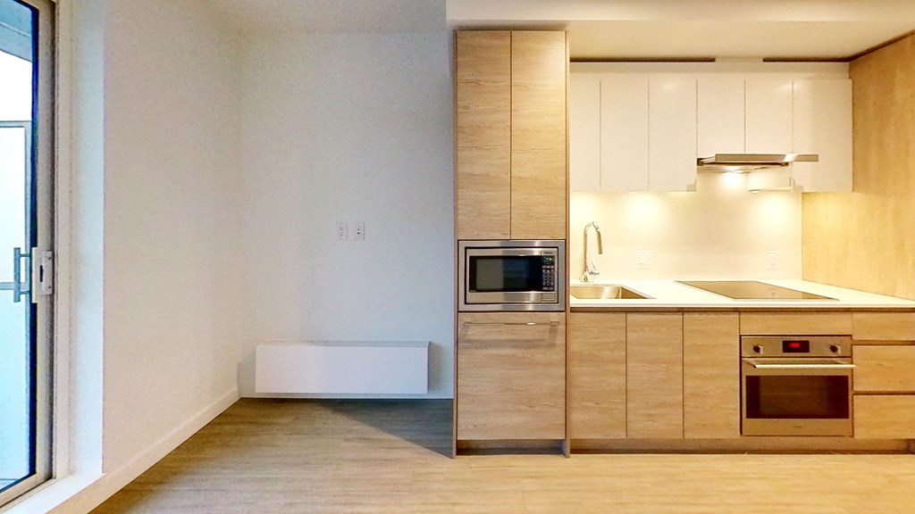 an empty kitchen with a sink and a microwave