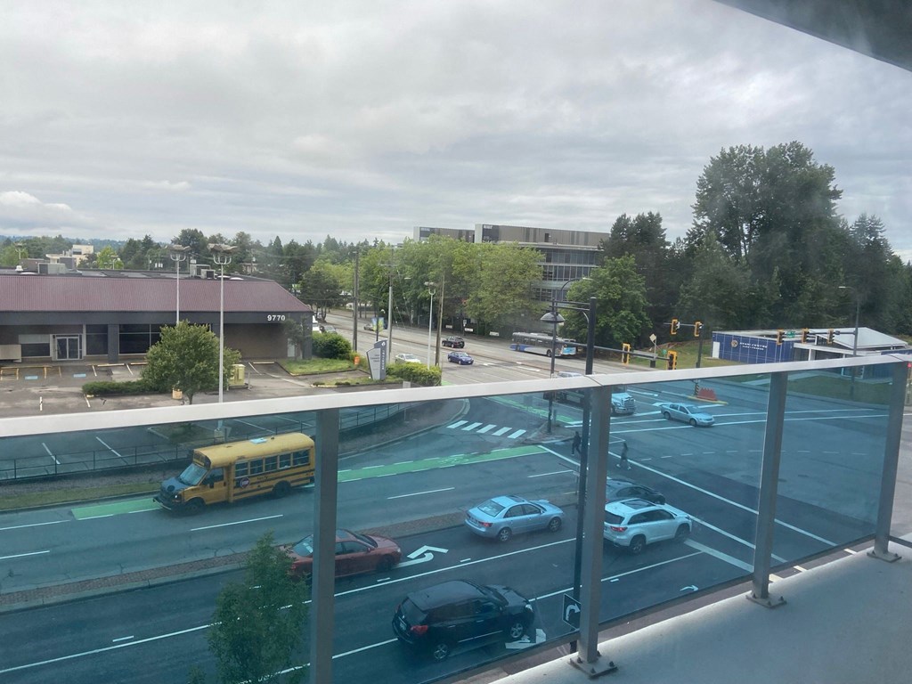 a view of a parking lot with cars and a school bus