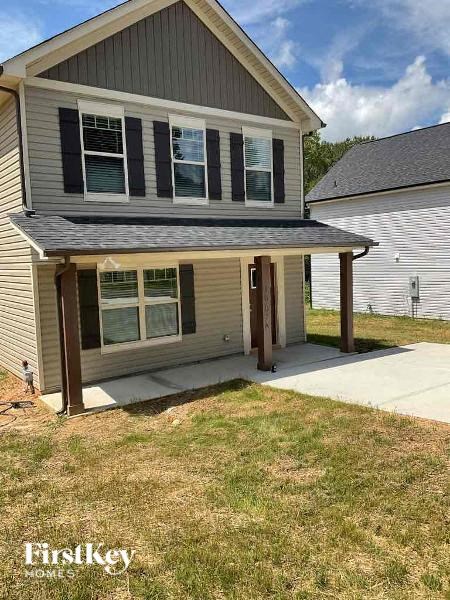 a house with a covered porch and a sidewalk