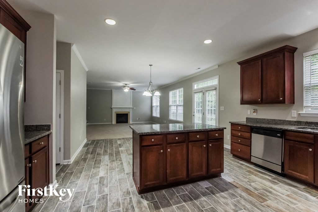 an open kitchen and living room with a fireplace