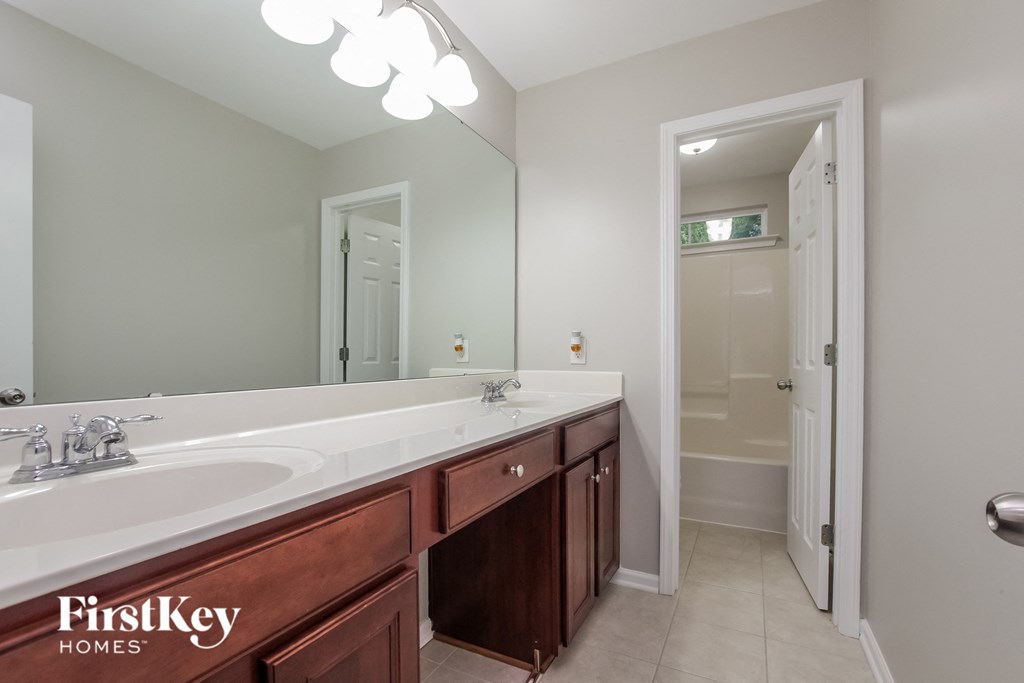 a bathroom with a large sink and a large mirror