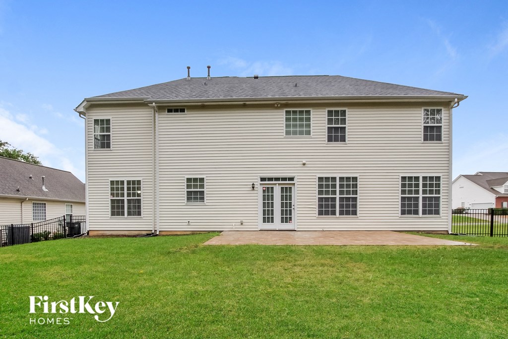 a white house with a yard in front of it