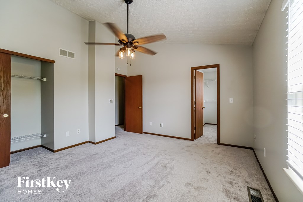 the master bedroom is spacious and has a ceiling fan