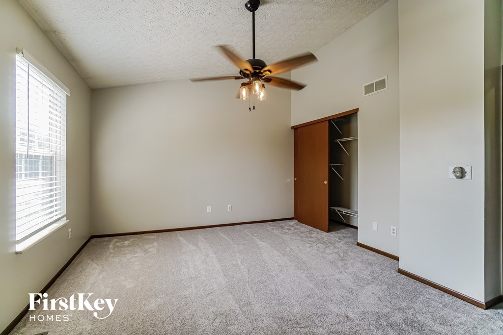the master bedroom is spacious and has a ceiling fan