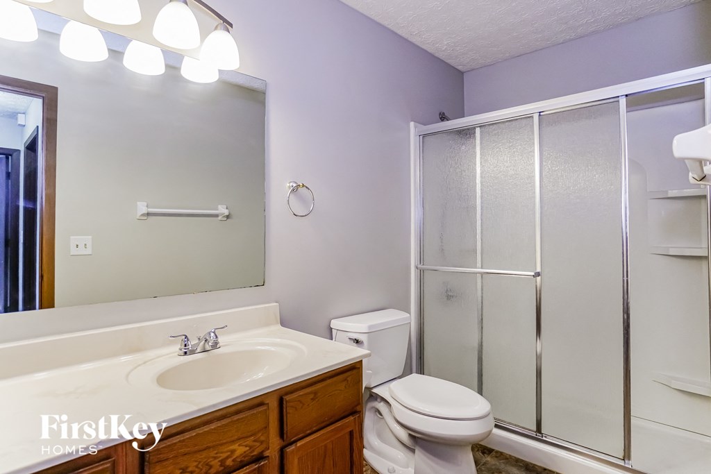 a bathroom with a sink toilet and a shower