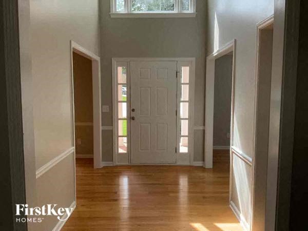 A white door is in the middle of a hallway.