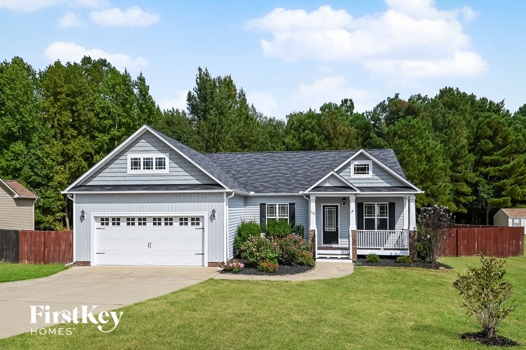 a white house with a blue roof and a garage