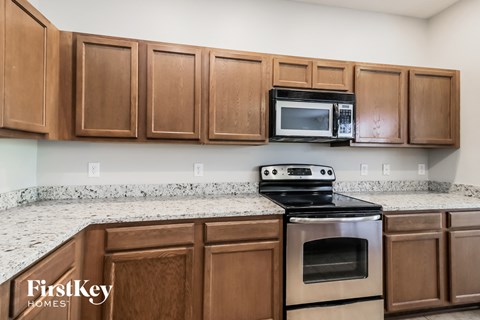a kitchen with wooden cabinets and stainless steel appliances