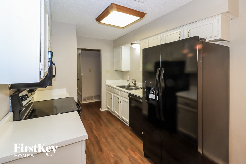 a kitchen with stainless steel appliances and white cabinets