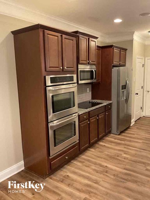 A kitchen with wooden cabinets and stainless steel appliances.