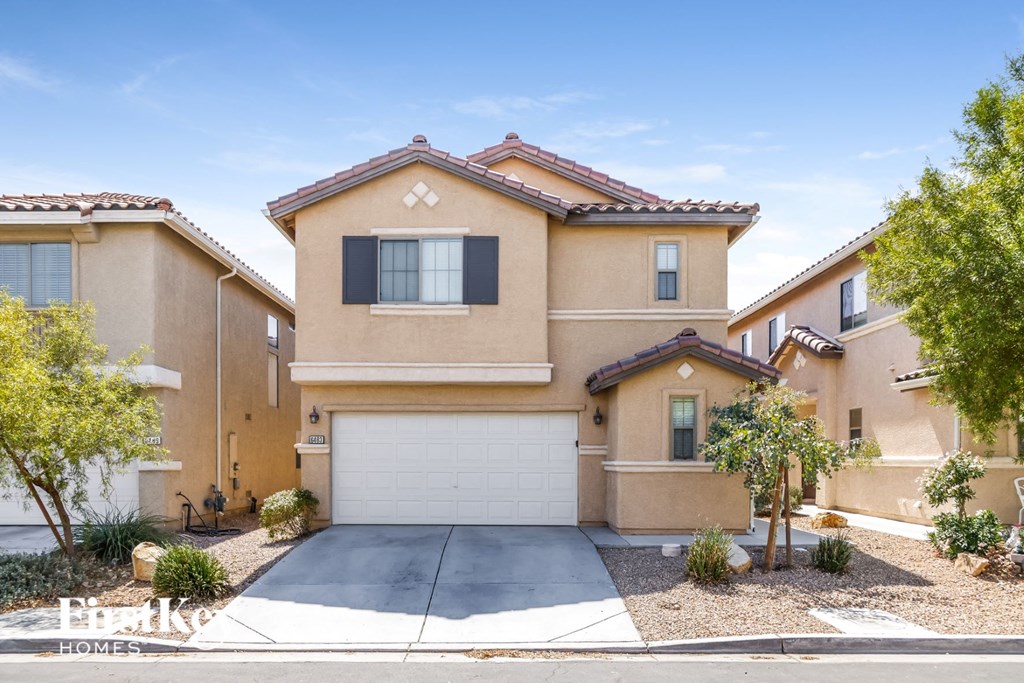 A large house with a driveway in front.