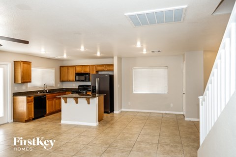 A kitchen with wooden cabinets and a white island.