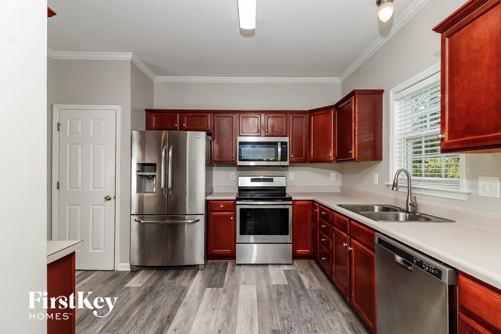A kitchen with wooden cabinets and stainless steel appliances.