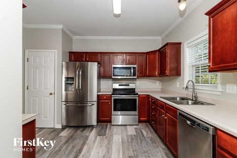 A kitchen with wooden cabinets and stainless steel appliances.
