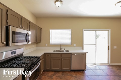 A kitchen with a stove top oven and a sink.
