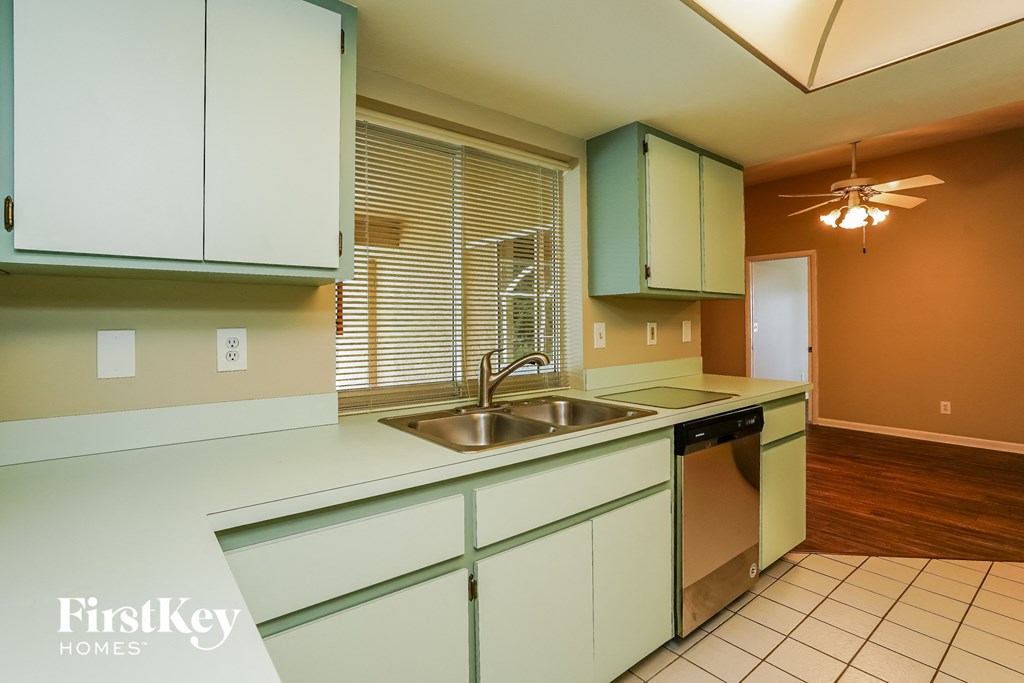 A kitchen with a sink and a dishwasher.