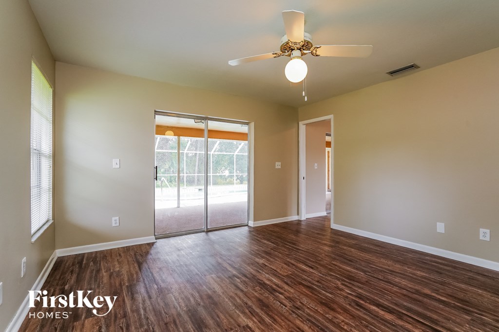 A room with wooden floors and a ceiling fan.