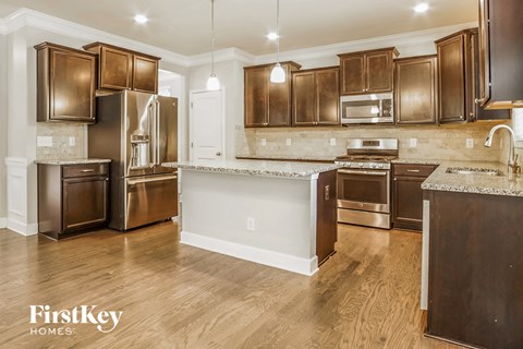 A kitchen with wooden cabinets and stainless steel appliances.