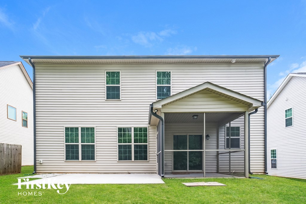A two-story house with a garage on the first floor and a covered entryway on the second floor.