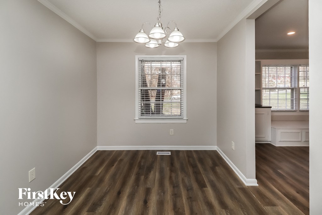 a living room with hardwood floors and a window