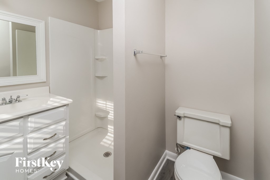 a small white bathroom with a toilet and a sink