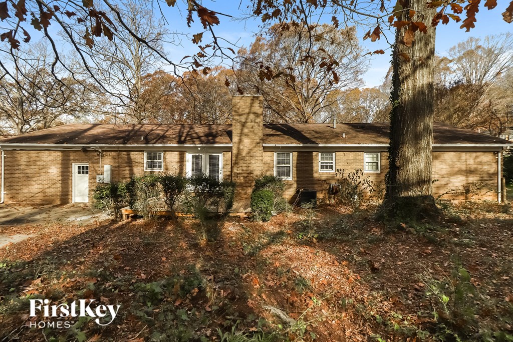 a brick house with a tree in front of it