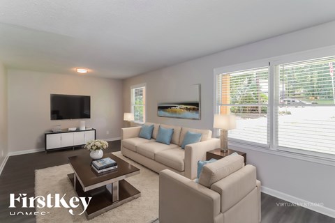 A living room with a white couch and a coffee table.