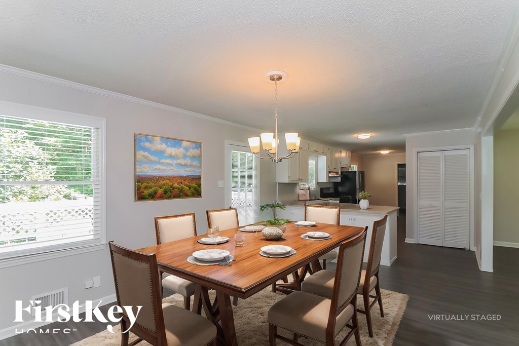 A dining room with a wooden table set for four.