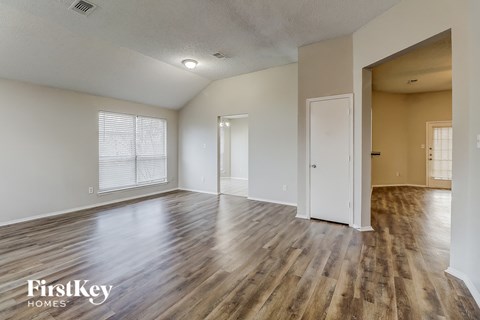 the living room and dining room with wood flooring