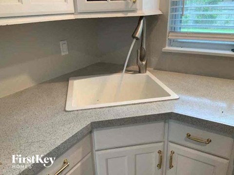 a kitchen with a sink and some white cabinets