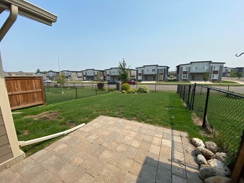 the backyard of a house with a yard and a fence