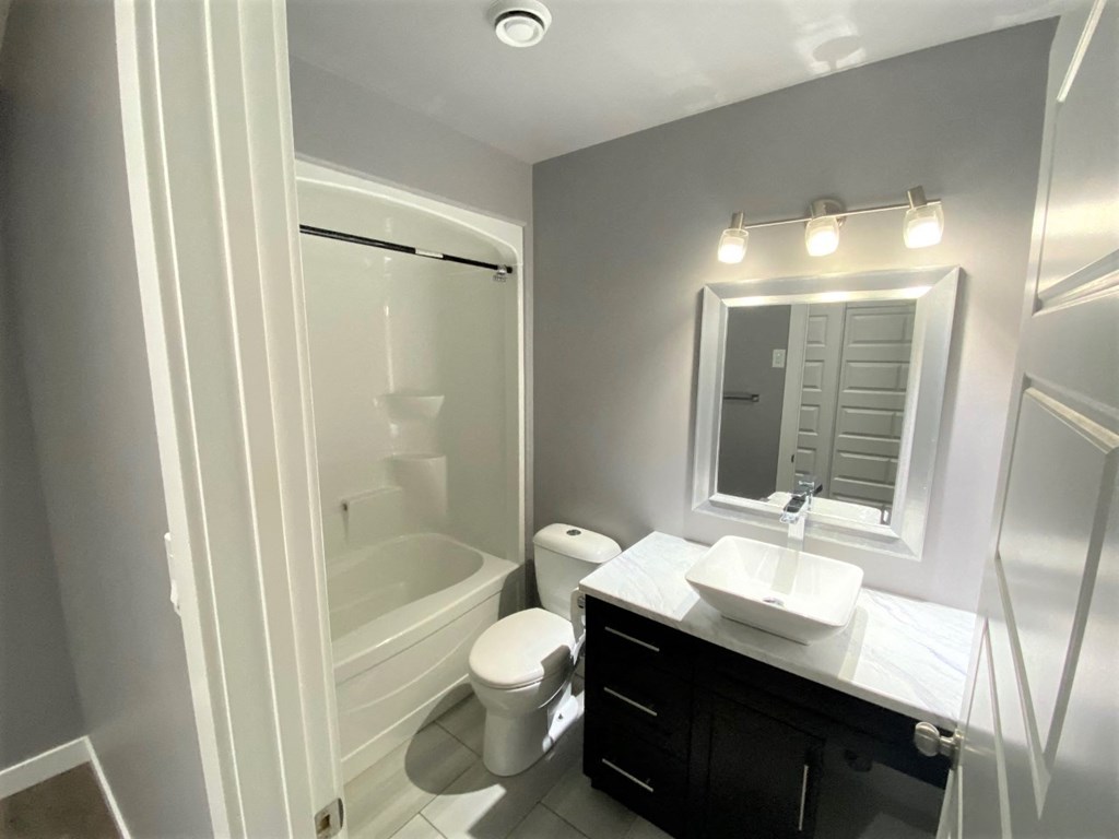 a bathroom with a sink toilet and a shower