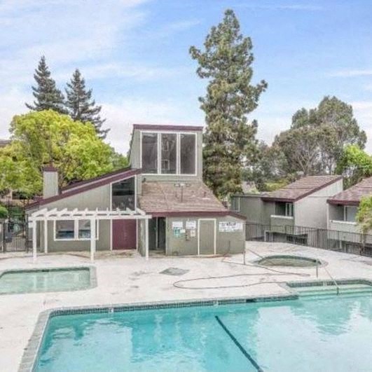 a house with a pool in front of it