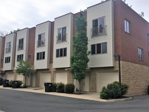 the exterior of an apartment building with brick and white siding