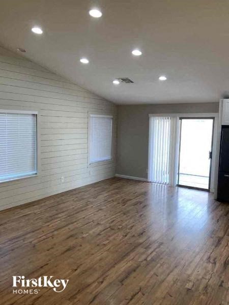 A room with wooden floors and a FirstKey Homes logo.