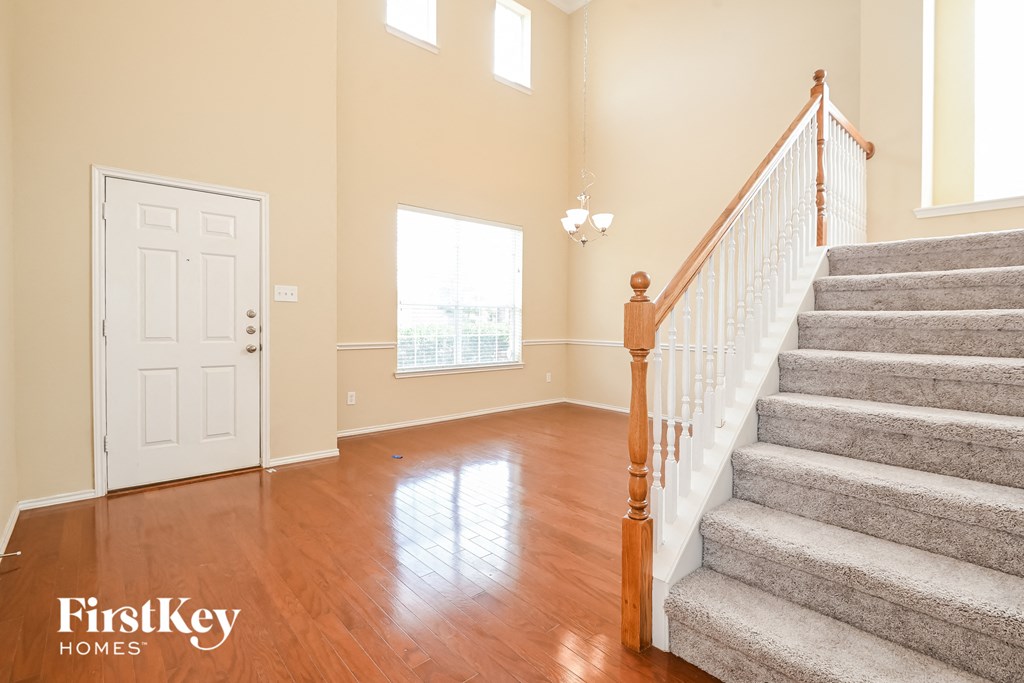 a fisheye view of the entryway of a home with a staircase