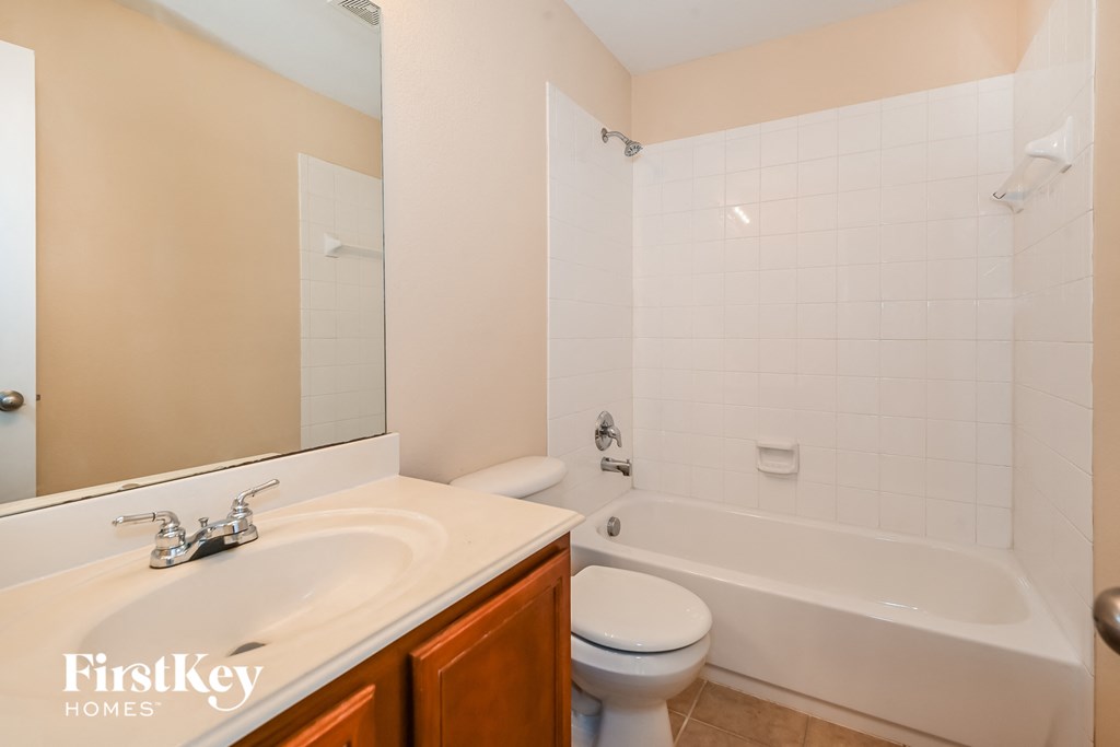 a bathroom with a sink toilet and a tub
