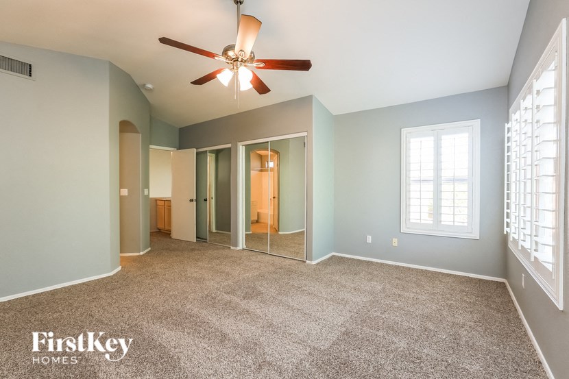 the master bedroom is spacious and has a ceiling fan