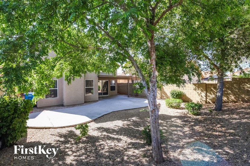 a house with a driveway and trees in front of it