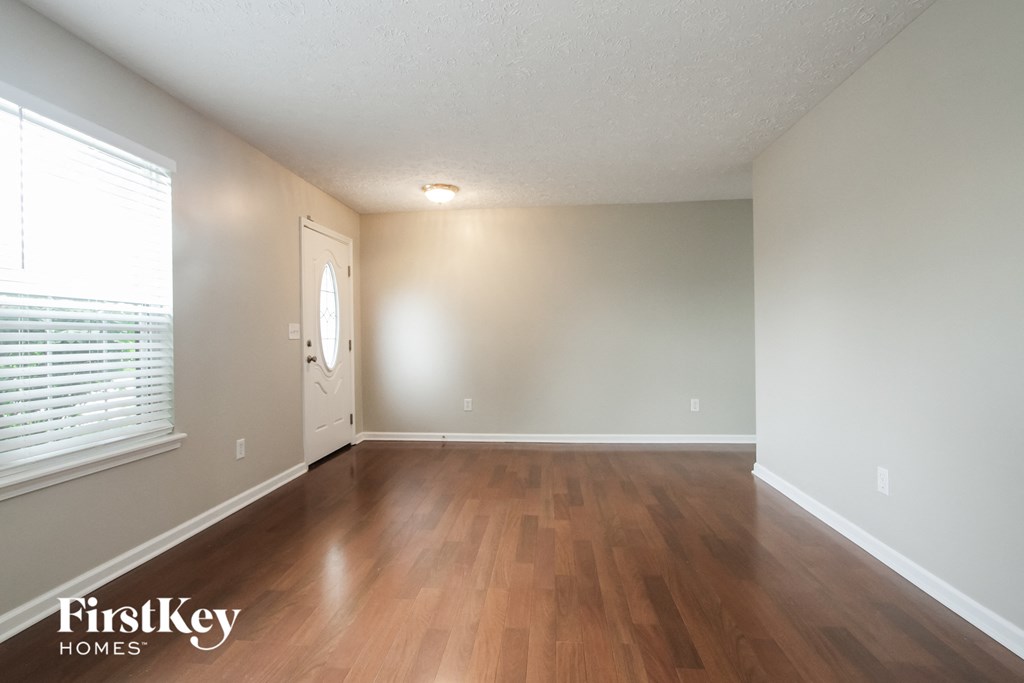 A room with wooden floors and a white door.