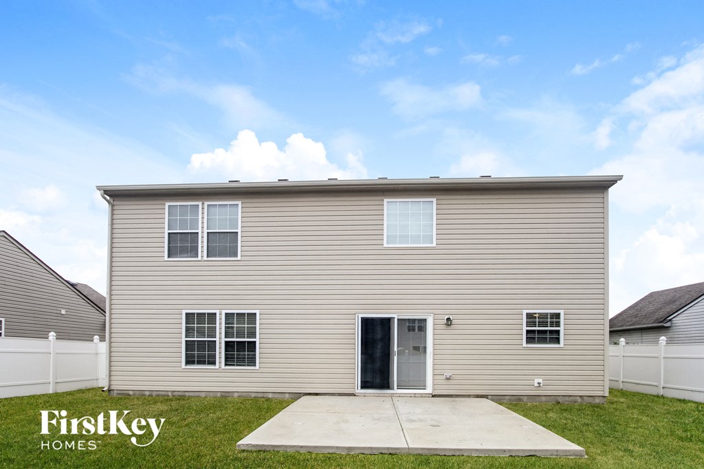 A two-story house with a garage door is for sale by FirstKey Homes.