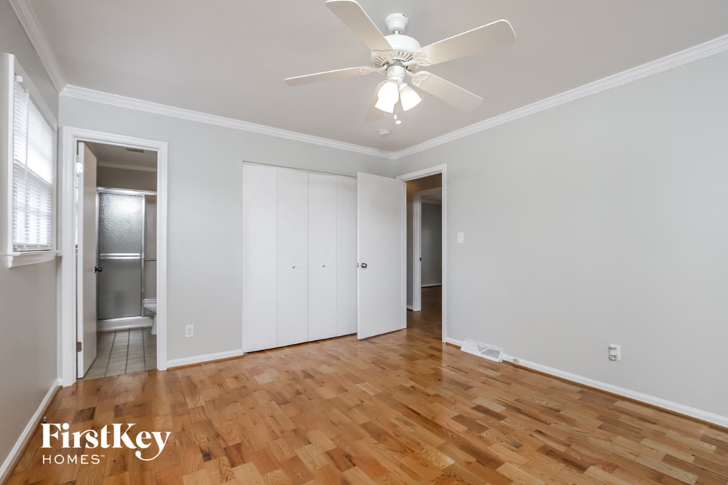 a living room with wood floors and a ceiling fan
