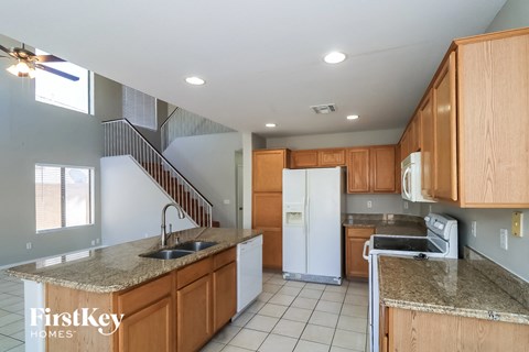 A kitchen with wooden cabinets and a granite countertop.