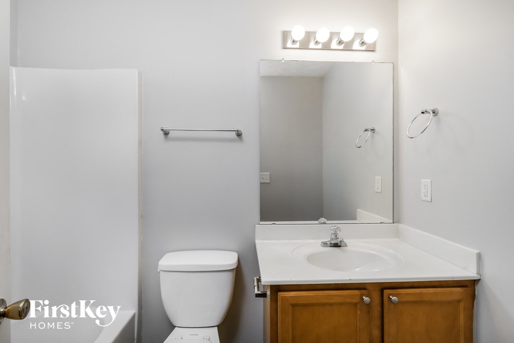 a small bathroom with a sink toilet and mirror
